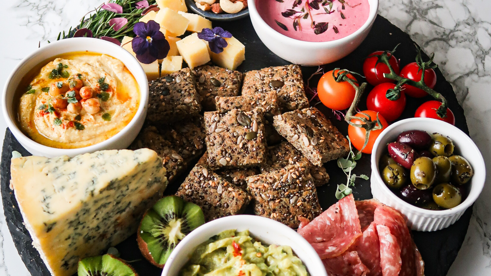 Keto-friendly Spring Grazing board with homemade seeded crackers